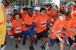 Excited children take off from the Marathon Mile starting line. © Take The Magic Step®