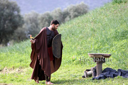 An ancient Greek warrior lights the marathon flame at the Marathon memorial. © www.photorun.net