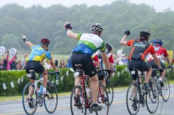 Uta and her fellow riders wave to the children of the summer camp at 'Da Hedge'—enthusiastic support for the cyclist on the second day of the ride. © John Deputy