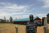 Paul Koech in front of his school building in Kenya. © Victor Sailer