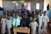 KIMbia’s Paul Koech with schoolchildren in Kenya. © Victor Sailer