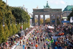 Competitors cross the finish line in front of the Brandenburg Gate in Berlin. © www.PhotoRun.net